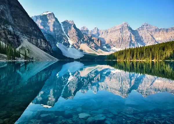 Mountains reflected in a turquoise lake in the Canadian Rockies